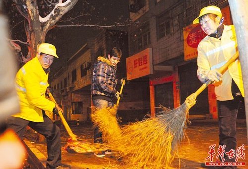 午夜寒风中,一家三口合力清扫马路。